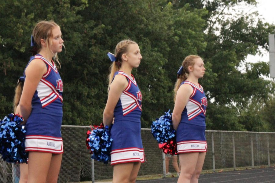 Paydin Baker, Maggie Watkins, and Piper Henson line up to watch the football game.
